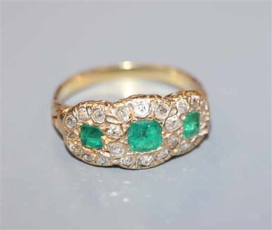 A yellow metal, diamond and emerald triple cluster dress ring, size M/N.